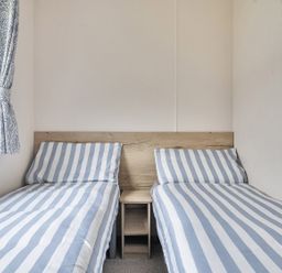 A bedroom with two single beds and a window at Ty dee seaview escapes in Looe