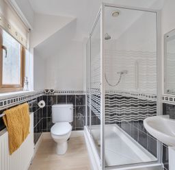 A bathroom with shower, toilet, and sink at 2 Bed, Sleeps 4 with Parking and EV charging in Wadebridge