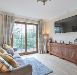 A living room with a sofa and television at 2 Bed, Sleeps 4 with Parking and EV charging in Wadebridge