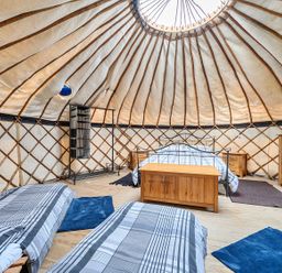 A bedroom with wooden furniture in a yurt at Yurt, Sleeps 5 and Dogs Welcome