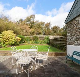 A garden with a table and chairs at The Old Dairy in 