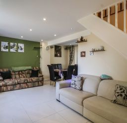 A living room with sofas and a dining area at 19 Hailey Road