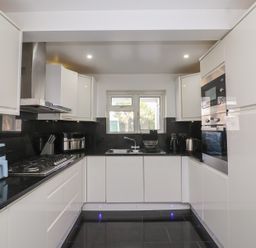 A kitchen with cabinets, sink, stove, and oven at 19 Hailey Road
