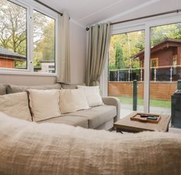 A living room with a sofa and table at Lake It Easy in Troutbeck Bridge