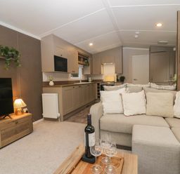 A living room with a sofa and coffee table at Lake It Easy in Troutbeck Bridge