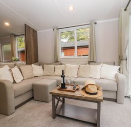 A living room with a sofa and coffee table at Lake It Easy in Troutbeck Bridge