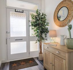 A hallway with a console table and plants at Bay View in Weymouth