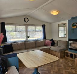 A living room with a sofa and a table at a property in unspecified location