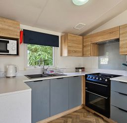 A kitchen with appliances and cabinets at The Old Barn in Manchester