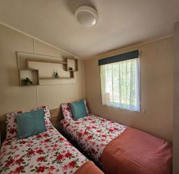 A bedroom with two beds and a window at the property in the location