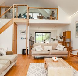 A living room with a sofa and coffee table at 1 Endellion View Wadebridge