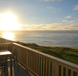 A deck with a table and chairs overlooking the ocean at Perran Sands Holiday Park - 621 Chy-an-Mor Perranporth