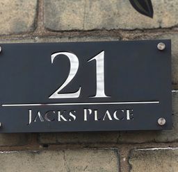 A house number sign for 21 Jacks Place on a wall in Whitby