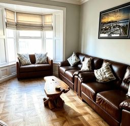 A living room with a sofa and armchair at Jacks Place in Whitby