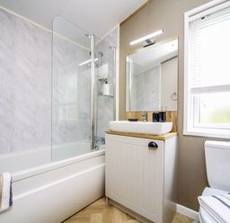 A bathroom with a bathtub, sink, and toilet at Hoburne Devon Bay - Woodland Glade 24, Paignton