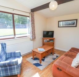 A living room with a sofa and television at Primrose Lodge Saltburn-by-the-Sea