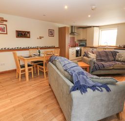 A living room with two sofas and a dining area at Cooper Cottage Potto near Stokesley