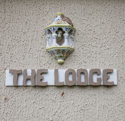 A sign that reads THE LODGE with a light fixture at The Lodge Old Buckenham near Attleborough