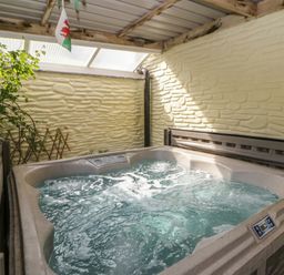 A hot tub in an indoor pool area at Yr Hen Llaethdy near Newcastle Emlyn