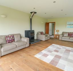 A living room with sofas and a fireplace at Chapel House Elim near Llanddeusant