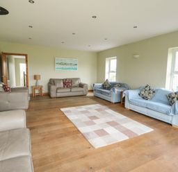 A living room with sofas and a lamp at Chapel House Elim near Llanddeusant
