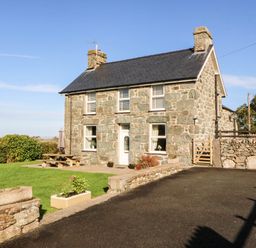 A house with a stone exterior and garden at Tyddyn in Dyffryn Ardudwy