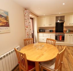 A kitchen with a dining table and chairs at The Old Bothy Bolton Low Houses near Wigton
