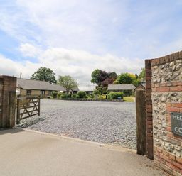 A gravel drive leading to cottages at Hedge End Farm Cottages in Winterborne Stickland