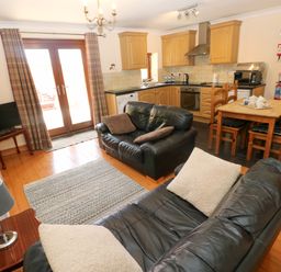 A living room with a sofa and TV at The Stall in Penuel near Llanmorlais