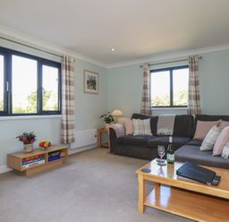 A living room with a sofa and coffee table at The Station Flat St Newlyn East near Newquay