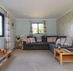 A living room with a sofa and table at The Station Flat St Newlyn East near Newquay