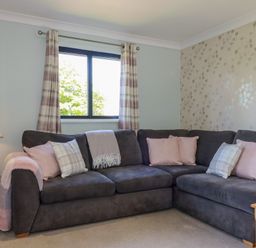 A living room with a sofa and side table at The Station Flat St Newlyn East near Newquay