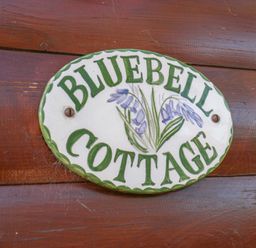 A sign that says Bluebell Cottage on a wooden surface at Bluebell Lodge in Saltburn-by-the-Sea