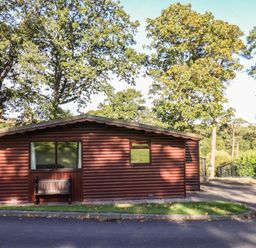 A cabin with windows and a bench at Bluebell Lodge Saltburn-by-the-Sea