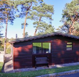 A cabin with a bench and windows at Violet Lodge in Saltburn-by-the-Sea