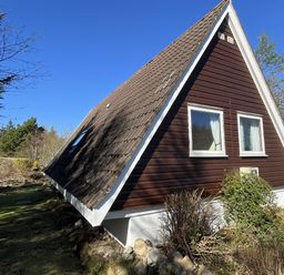 A house with a sloped roof and windows at Suil Na Mara Aultbea