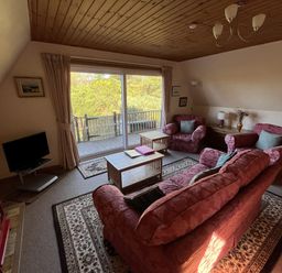 A living room with a sofa and armchairs at Suil Na Mara in Aultbea