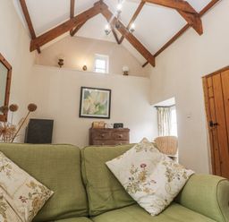 A living room with a sofa and chest of drawers at Swallows St Keverne Lizard Peninsula
