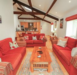 A living room with sofas and a coffee table at Winster Fields, Cartmel Fell near Windermere