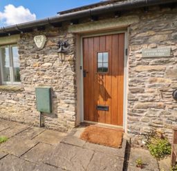 A doorway with stone wall and pathway at Winster Fields, Cartmel Fell near Windermere