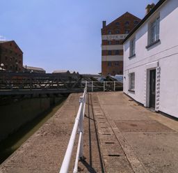 A canal with a bridge and buildings at The Lock House Gloucester