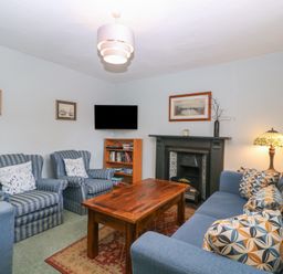 A living room with a sofa and armchairs at The Lock House in Gloucester