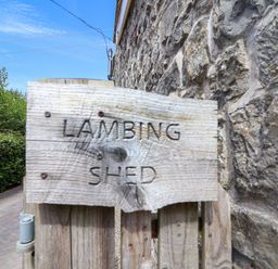 A wooden sign stating Lambing Shed at The Lambing Shed Dyserth near Prestatyn