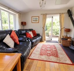 A living room with a sofa and coffee table at The Lambing Shed in Dyserth near Prestatyn