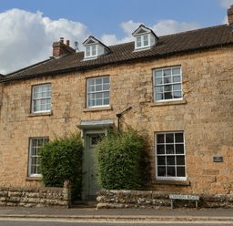 A house with stone exterior and windows at The Lodge Snainton near Scarborough
