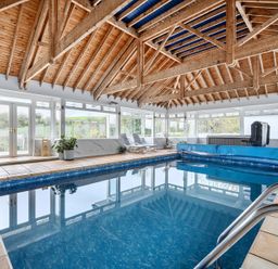An indoor pool area with a hot tub at Chapel Green in Polgooth