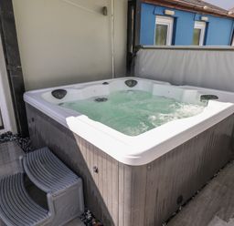 A hot tub with steps at Meadow View in Laugharne