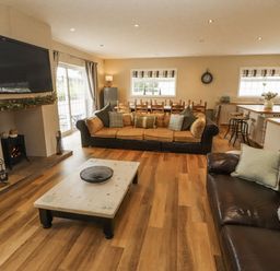 A living room with a sofa and coffee table at White Gables in Great Clifton near Cockermouth