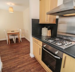 A kitchen with wooden floor and dining table with four chairs at No 2 Low Hall Cottages Scalby near Scarborough