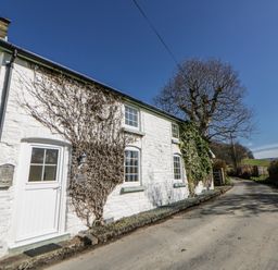 A cottage exterior along a road at Penlone Cottage in Rhayader